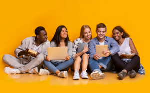 Students sitting reading together against a yellow background